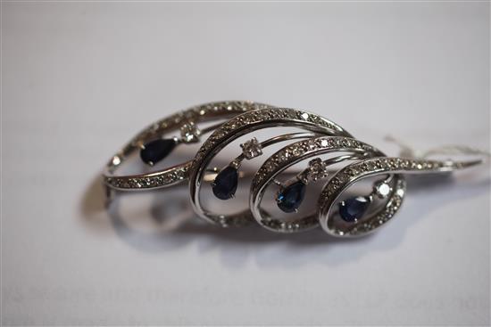 An 18ct white gold, sapphire and diamond brooch, 2.25in.